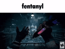 a person is holding a pen in a dark room with the word fentanyl written on it .