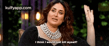 a woman wearing a pearl necklace is sitting in a chair and saying `` i think i would just kill myself ''
