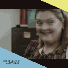 a woman is smiling in front of a freelancers anonymous banner