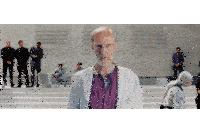 a man in a lab coat stands in front of a group of men