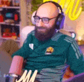 a man with a beard wearing headphones and glasses