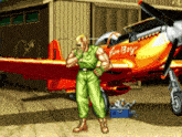 a man stands in front of a plane that says " fine boy " on it