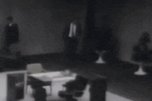 a man in a suit and tie is standing in a dark room