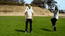 two men are standing in a grassy field with the word ai written above them