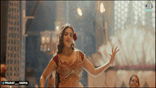 a woman is dancing in front of a screen that says pranay varma