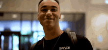 a young man wearing a black shirt that says space