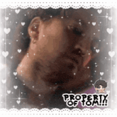 a picture of a man with hearts and the words property of tom