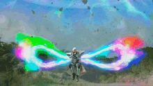 a person flying through the air with a rainbow of colors