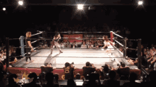 two women wrestling in a ring with a banner that says ' g ' on it