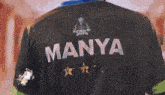 a person wearing a black shirt that says manya