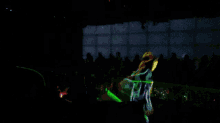 a painting of a person in a dark room with green and purple lights