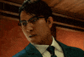 a man wearing glasses and a suit is looking at something