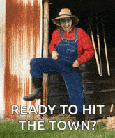 a man in overalls and a hat is sitting on the side of a building with the words ready to hit the town below him