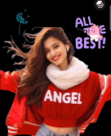 a woman wearing a red sweater that says angel is smiling