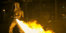 a man in a protective suit is holding a fire hose