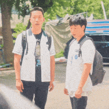 two young men standing next to each other with one wearing a shirt that says ' city '