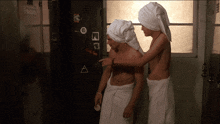 two men with towels on their heads in front of a locker that says raiders
