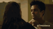 a woman is touching a man 's neck with the hashtag @tvresidence behind them