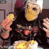 a person with a cake on their face is being hosted by mad dawg a.