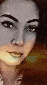 a close up of a woman 's face with a slight smile on her face