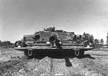 a black and white photo of a military vehicle in the dirt