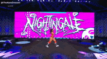 a woman is dancing in front of a large screen that says nightgale