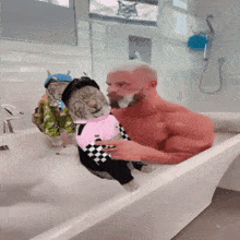 a shirtless man is taking a bath with two cats wearing costumes