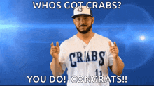 a man wearing a jersey that says crabs congratulates someone