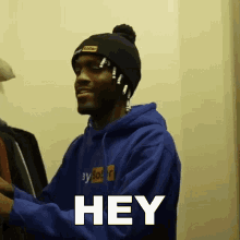 a man in a blue hoodie says hey