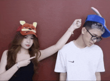 a man wearing glasses and a woman wearing a winnie pooh hat