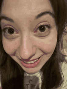 a close up of a woman 's face smiling