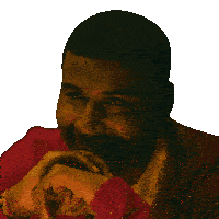 a close up of a man 's face with his hands folded on his chin