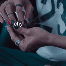 a close up of a person 's hands with the word chy written on the bottom