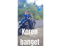 a young boy is holding a toy truck that says keren banget on the bottom