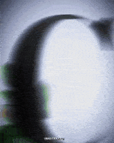 a blurred image of a person 's face with the word ina strato on the bottom right