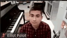 a young man is sitting in front of a piano .