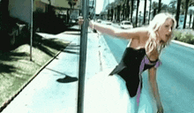 Swinging-on-pole Woman-hanging-on-to-pole GIF - Swinging-on-pole Woman-hanging-on-to-pole Hanging-on-to-sign GIFs