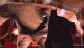 a cartoon of a man standing next to a batman in a dark room .