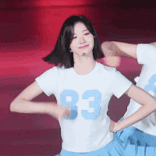 a girl in a white shirt with the number 83 on it