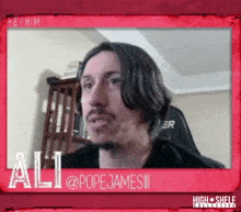 a man with a beard is in a red frame with the name ali on it