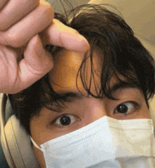 a close up of a person wearing a face mask and headphones