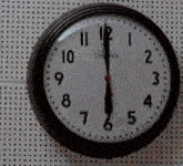 a clock on a wall shows that it is almost eleven o'clock