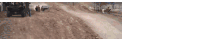 a group of people are walking down a dirt road ..