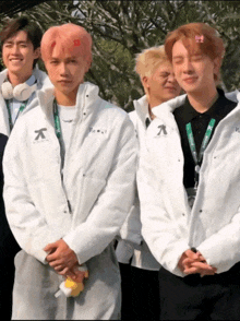 a group of young men wearing white jackets with the letter k on the front