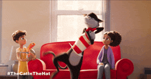 a cat in a hat is playing with two children