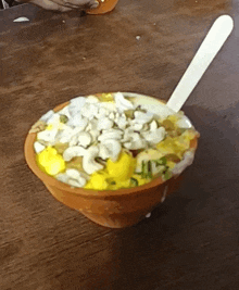 a bowl of food on a table with a spoon in it