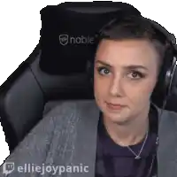 a woman wearing headphones is sitting in a chair with the words elliejoypanic on the bottom