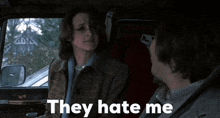 a man and a woman in a car with the words they hate me on the bottom