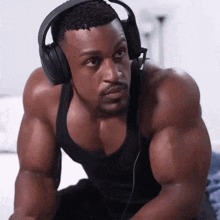 a muscular man wearing headphones and a black shirt