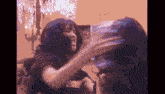 a woman is holding a large container of water in her hands .